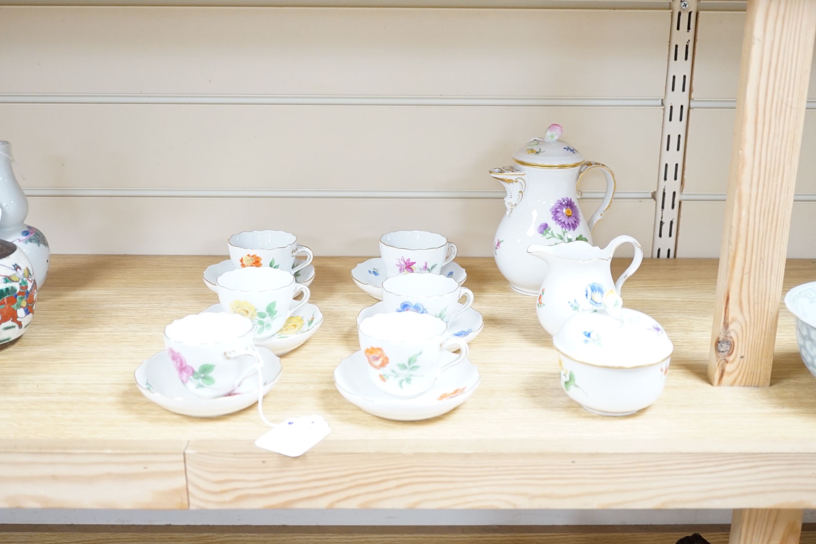A 20th century Meissen coffee set with floral decoration, comprising a coffee pot, a milk jug, a lidded sugar bowl, and six cups and saucers, coffee pot, 17cm high